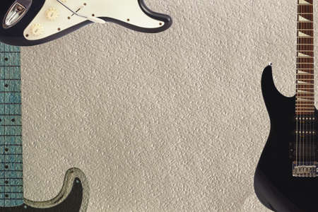Black and grey electric classic and rock guitars on the rough cardboard background, with plenty of copy space.の写真素材