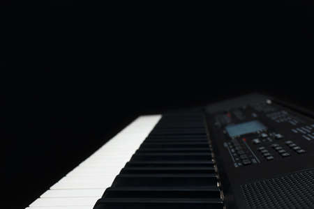 Keyboard of the digital synthesizer on a black background