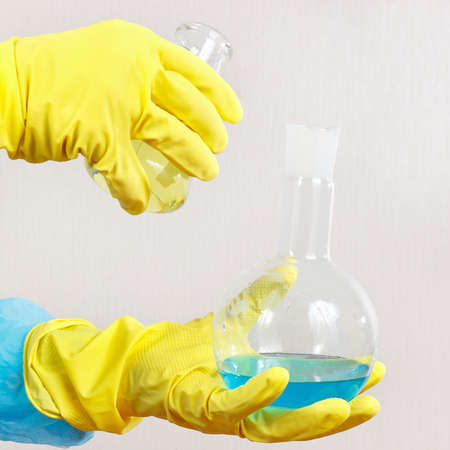 Scientist hands in rubber gloves is engaged in chemical experiments in the laboratory