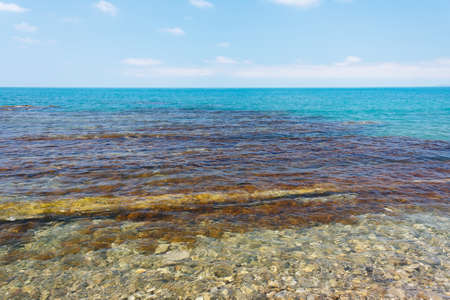 Charming sea view with a coastal reefs and clear waterの写真素材