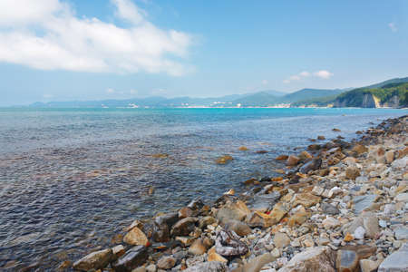 Beautiful view of the sea and the forested mountain seashoreの写真素材