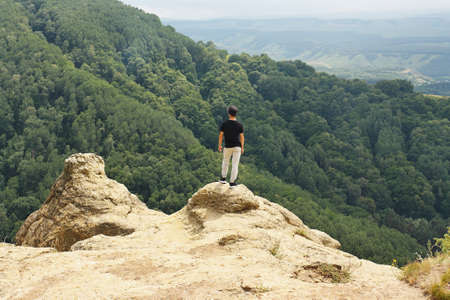 Tourists looking from high mountain to the amazing view below.の写真素材