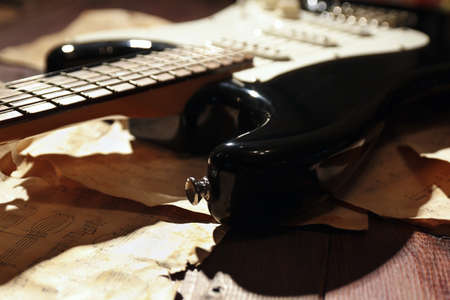 Still life with an electric guitar and vintage music notes close up.の写真素材