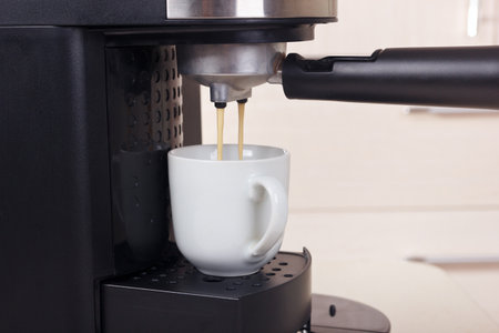 Making cup of coffee in a carob coffee machine.の写真素材