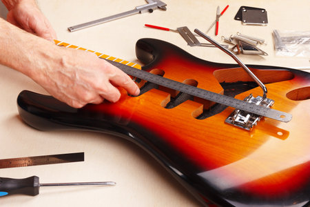 Guitar master measures distance of tremolo installation on the electric guitar.の写真素材