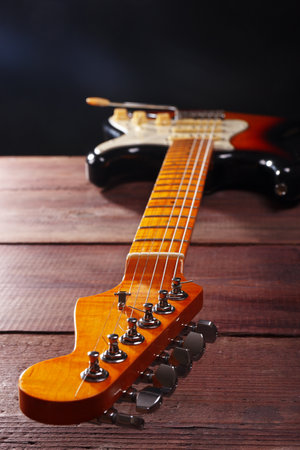 Sunburst vintage electric blues guitar closeup on the wooden background. Selective focus.の写真素材