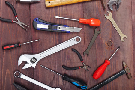 Variety of plumbing tools for repair work on a wooden workshop. View from above.の写真素材