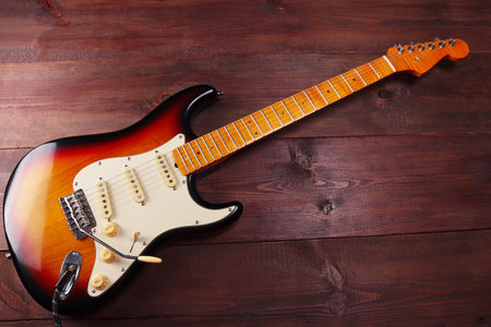 Vintage electric blues guitar on the wooden background.の写真素材