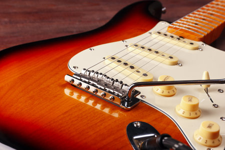Vintage electric guitar closeup on the wooden background. Selective focus.の写真素材