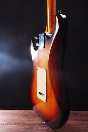 Vintage electric blues guitar on the wooden floor. Back view.の写真素材
