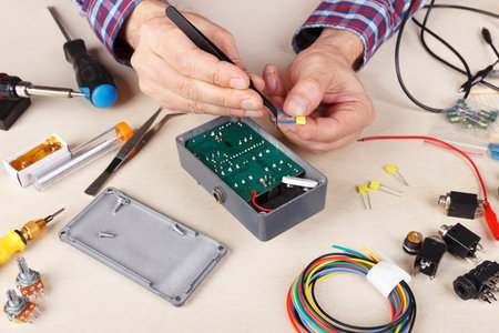 Master servicing electrical hardware at the service workplace.