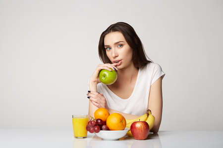 woman beauty girl with fruits basket on gray white backgroundの写真素材
