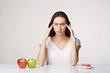woman beauty girl with fruits and donut apple on gray white backgroundの写真素材