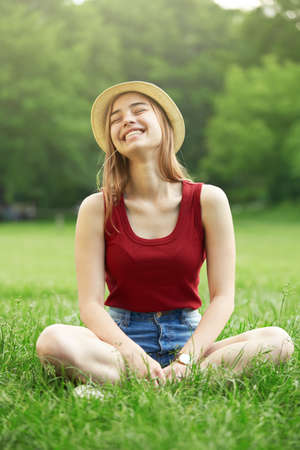 cute happy girl on grass summerの写真素材