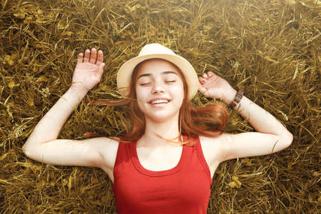 cute happy girl on grass autumnの写真素材