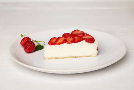 Sweat cake with strawberry on plate on wooden backgroundの写真素材