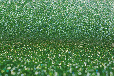 Blurred shining closeup of green bright art texture. Macro design of classic glittering backdrop, soft selective focus. Color concept.の写真素材