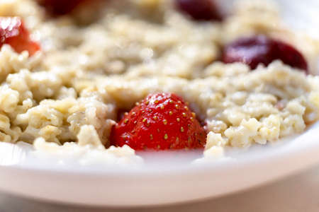 Homemade Porridge with strawberries. Hot and healthy food for breakfastの写真素材