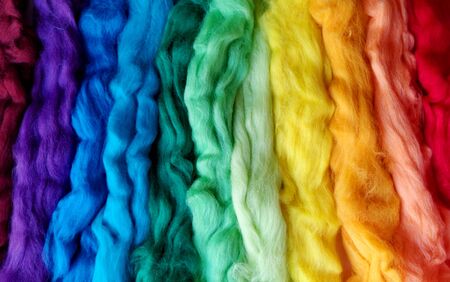 wool for felting different colors of the rainbow. striped woolen background. textural abstract colorful backgroundの写真素材
