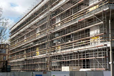 Scaffolding at construction site at the entire length of building 