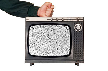 Clenched fist strikes broken retro vintage TV  No signal noise at screen の写真素材