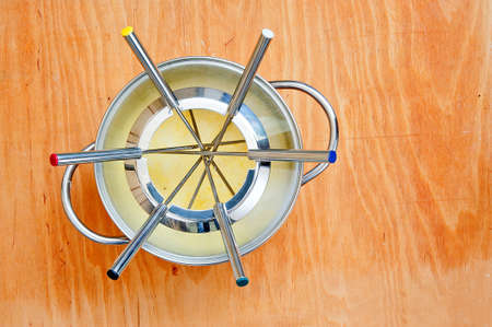 fondue pot at wooden backgroundの写真素材