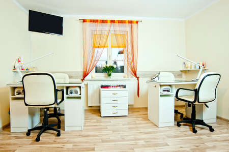 manicure or cosmetic salon interior  Desks and chairs at wooden floor の写真素材