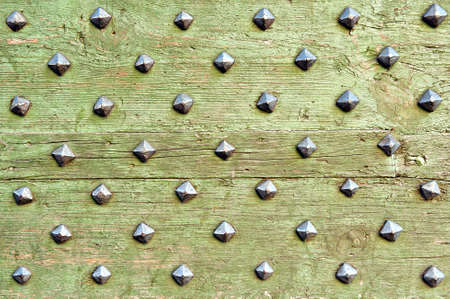 green old boards with metal studsの写真素材