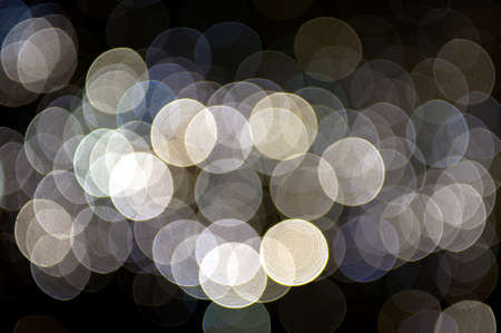 blurred, defocused bright lights on black backgroundの写真素材