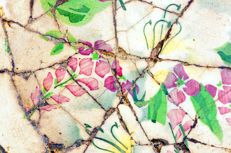 Close up of cracked porcelain with floral design