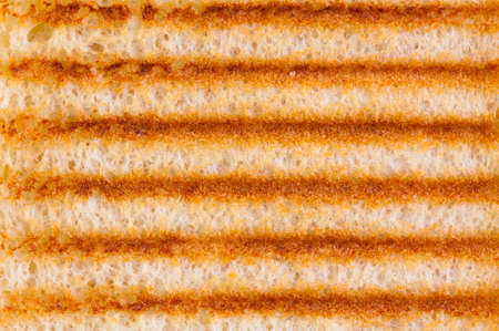 Abstract background of close up on toasted bread with grill marksの写真素材