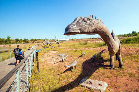 KRASIEJOW, POLAND - 21 August 2018 JuraPark - theme park in Poland devoted to dinosaurs. Visitors passing byのeditorial素材