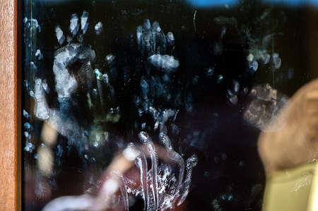 window stained by children dirty handsの写真素材