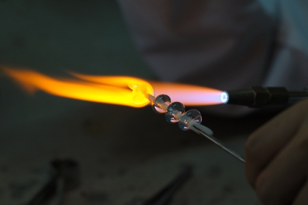 Shaping glass in fire