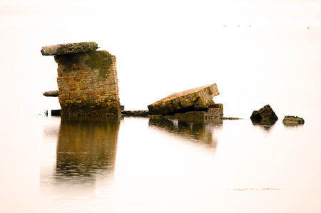 Deserted and dilapidated building in the middle of sea (Italy, Valle Cavanata nature reserve).の写真素材