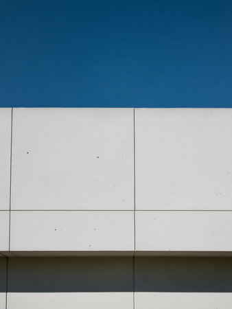 Architectural detail of a white wall with blue sky as backgroundの素材