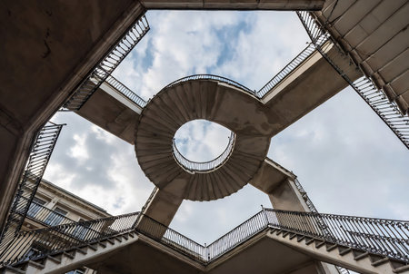 Spiral staircase with blue sky and white clouds, Paris, Franceの素材