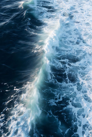 Aerial view of the waves in the ocean on a sunny dayの素材