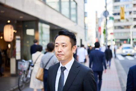 Portrait of a businessman walking in the street in Tokyo, Japanの素材