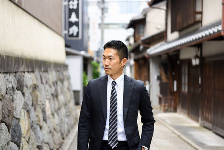 Businessman walking in the street in Japan. Asian male model.の素材