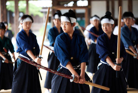 Japanese martial arts training, group of young people practicing kendo in the gymの素材