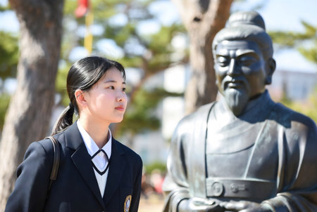 Japanese elementary school girl looking at the statue of the king of Japanの素材