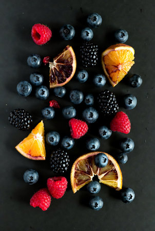Fruit and berry pattern on black background. Top view.の素材
