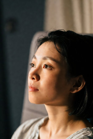 Portrait of a beautiful Asian woman looking at the camera with her eyes closedの素材