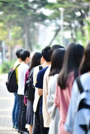 Back view of group of students walking on the street. Back to school concept.の素材