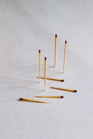 Wooden matchsticks on a white background. Selective focus.の素材