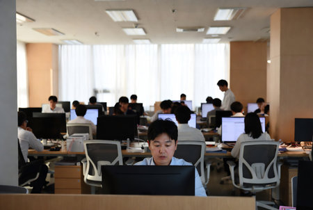 Group of young asian business people working on computer in the officeの素材