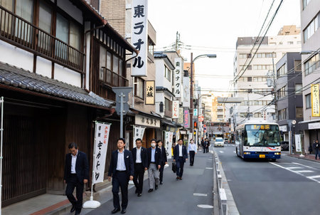 Unidentified people walk on the street in Kyoto, Japan. Kyoto is the capital and largest city of Japan.の素材