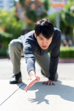 Asian man doing push up exercise in the park - focus on handの素材