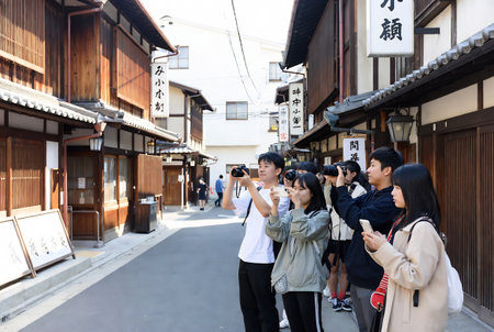 Tourists taking photos of old town in Kyoto, Japanの素材